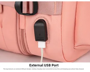 Detail of travel backpack with integrated external USB charging port and connected cable