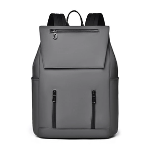 Front detail of gray waterproof backpack featuring three zippers and flip-top cover