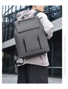 Macro detail of dark grey matte waterproof backpack with vertical zipper pockets