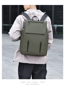 Detail view of olive green commuter backpack with waterproof matte finish and zip pockets
