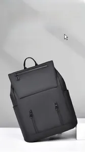 Detail of high-capacity black matte backpack with front zipper pockets and top handle