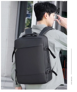 Detail of black business laptop backpack side view showing USB port and adjustable buckle