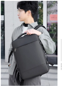 Side view of professional matte black business backpack on model in urban city setting