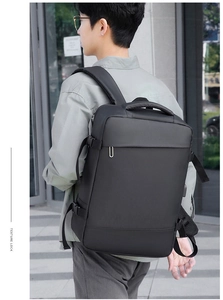 Side view of black business backpack featuring compression straps and breathable straps
