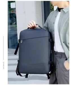 Detail of dark blue business backpack showing waterproof fabric and textured finish