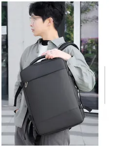 Business laptop backpack in black matte leather finish worn by male model outdoors