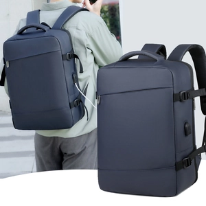 Detail of navy business backpack featuring side compression straps and external USB port