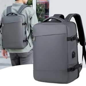 Gray business backpack featuring external USB charging port and adjustable side buckles