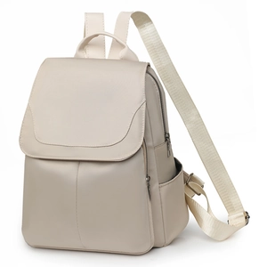 Side view of beige oxford fabric backpack featuring a flap top and adjustable nylon straps