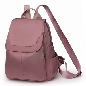 Detail view of pink Oxford fabric backpack with dual zippers and side water bottle pocket