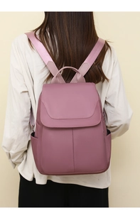 Back view of a woman wearing a stylish purple anti-theft Oxford cloth backpack for daily travel