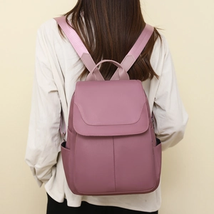 Close-up of pink Oxford fabric anti-theft backpack with adjustable shoulder straps