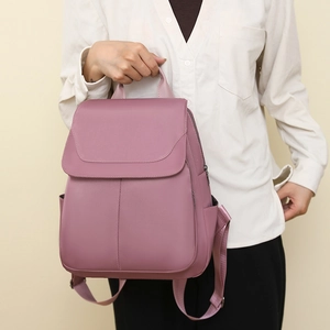 Detail view of anti-theft oxford backpack in vintage purple with side pockets and top handle