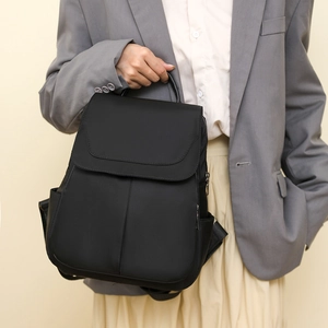 Close-up of matte black oxford fabric and anti-theft zipper on the backpack