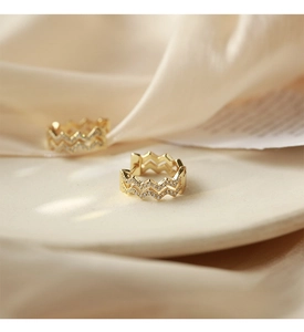 Detailed close-up of gold double-layer wavy hoop earrings with pavé-set cubic zirconia