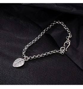 Detailed close-up of vintage S925 silver leaf pendant on a chain bracelet with hooked clasp