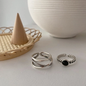 Vintage oxidized silver ring set featuring crisscross bands and black stone inlay