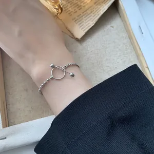 Detail of S925 silver beaded and twisted chain bracelet with toggle OT clasp on wrist