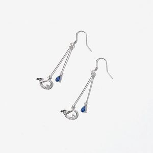 Detailed view of silver whale earrings with blue teardrop crystals and shimmering zircon