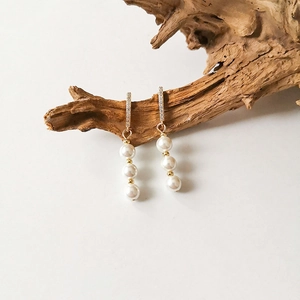 Detail of S925 silver earrings with triple freshwater pearls and pavé cubic zirconia studs