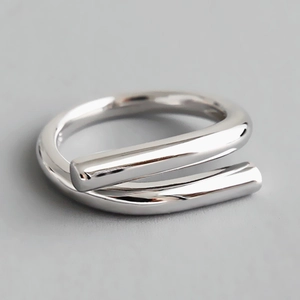 Minimalist double layered wrap ring with a polished silver mirror finish on a smooth surface
