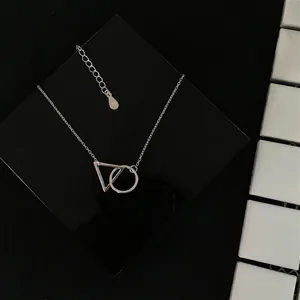 Detail of S925 sterling silver necklace showing interlocking geometric triangle and circle