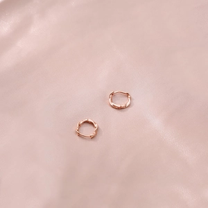 Rose gold Mobius twist earrings in S925 sterling silver on pink silk background