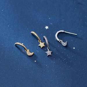 Macro detail of S925 silver star and moon earrings with pavé cubic zirconia inlay
