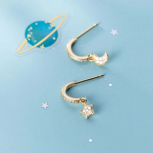 Detail of gold-plated S925 silver star and moon earrings with cubic zirconia inlay
