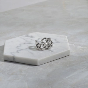 Detail of S925 sterling silver chain link ring on white marble display stand