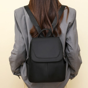Minimalist black oxford fabric anti-theft backpack shown on model for size and fit