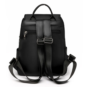 Detail of the hidden anti-theft back pocket and adjustable straps on black Oxford backpack