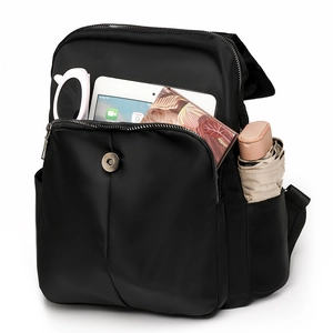 Detail view of large capacity black backpack showing interior storage for tablets and gadgets