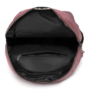 Interior view showing spacious main compartment and silver zipper pocket of pink backpack