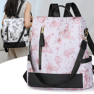 Detail of floral butterfly print on a durable nylon backpack with leather accents