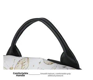 Close-up of rounded black leather handle with golden butterfly embroidery on white nylon