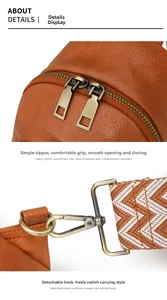 Detalle de bolso bandolera de cuero marrón con cremalleras de bronce y correa de tela
