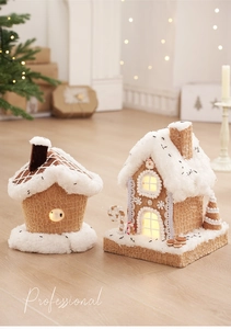Close-up of lighted fabric gingerbread house decor with faux snow and waffle texture