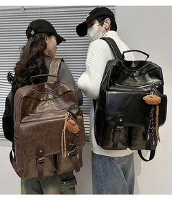 Brown and black retro PU leather backpacks with plush bear charms shown on models
