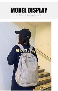 Side view of large light grey casual backpack on model showing capacity and sleek design