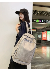 Side view of large casual laptop backpack on model in urban subway station setting