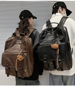 Detailed view of vintage faux leather backpacks with plush bear charms and side pockets