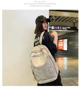Detail view of the gray minimalist backpack with smooth matte texture and side pocket