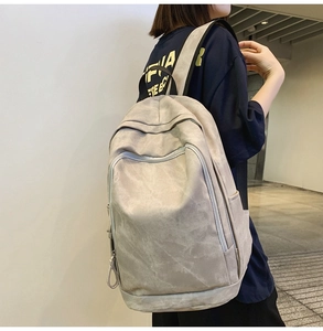 Side view of the minimalist grey backpack showing high capacity and ergonomic shoulder straps