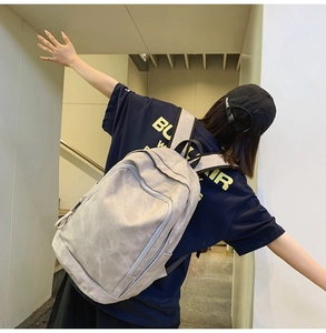 Close-up of minimalist backpack with water-resistant fabric texture on a model