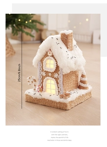 Macro view of a 25cm light-up gingerbread house with faux snow and warm LED lighting