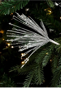 Detail of silver glittered Christmas picks with beads on a festive tree branch