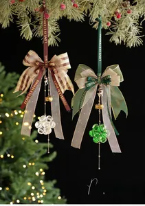 Detail of Christmas ribbon ornaments with golden bells and crystal beads on a festive tree