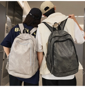 Rear view of minimalist large capacity travel backpacks in light and charcoal grey