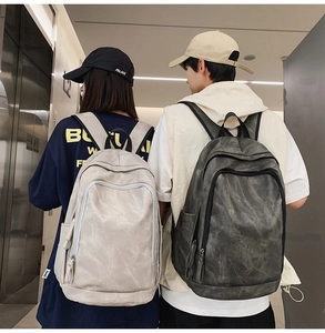 Close-up of minimalist large-capacity backpacks in grey featuring a unique washed texture